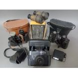 A box of vintage cameras and binoculars to include a Comet 355 bluestar, box camera and Prinz