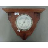 A 1930s walnut cased wall hanging barometer.