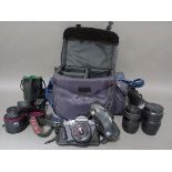 A Pentax camera with various lenses in padded carry bag.