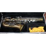 A Selmer Bundy II brass alto saxophone with hard case.