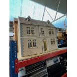 A dolls house with interior furniture.