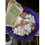 A tub of world coins and banknotes