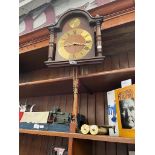 A Hermle wall clock with weights and pendulum.