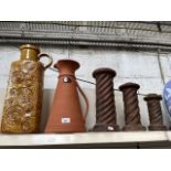 A large West German bottle shaped vase, with handle on collar, together with a large terracotta jug,