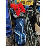 A bag of golf clubs and a trolley.
