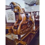 A carved wood rocking horse by Ian Armstrong, length 126cm.