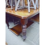 A Victorian wind out mahogany dining table with extra leaf.