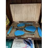 A cased blue enamel vintage dressing table set.