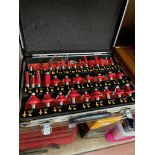 A cased set of router bits.