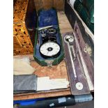 A handheld Smiths tachometer in case, a boiler related slide rule and a cased planimeter.