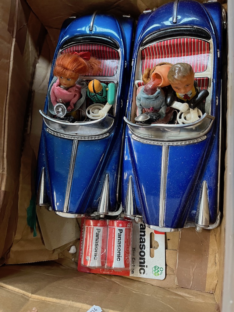 Two tin plate electric toy cars.
