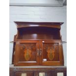 An Arts & Crafts inlaid walnut wall cabinet together with a yew wood tripod table.