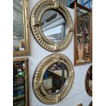 A pair of circular gilt framed mirrors, diameter 58cm.