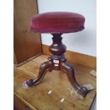 A Victorian rosewood adjustable piano stool.