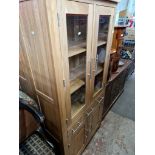 Two modern light oak cabinet bookcases together with two white bookcases.