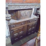 An early 20th century carved oak court cupboard.