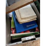 A box of music scores and piano music.