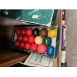 A boxed set of Aramith billiard balls.