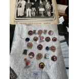 A collection of 18 Butlins Holiday Camp pin badges from the 1960s together with some photographs
