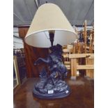 A figural table lamp modelled as a man with horse.