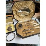 A vintage manicure set in original case, a small bottle with hallmarked silver lid, and a hallmarked