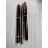 Two Waterman and a Sheaffer fountain pens.
