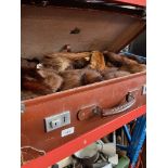A large vintage case and a bag of various furs.