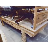 An eastern carved wood bench decorated with dragons, length 200cm.