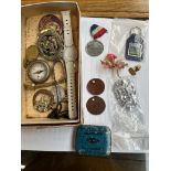 A small box of bric a brac to include watches, compass, dog tags, military insignia and coronation