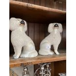 A pair of pottery Poodle Dogs