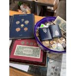 A tub of world coins and banknotes and an American dollar set and an English coins set.