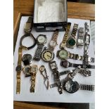 A box containing various gents and ladies watches and a pocketwatch.