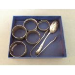 A collection of hallmarked silver items; napkin rings, sugar tongs and a silver spoon, various
