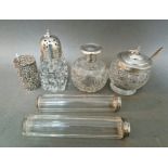 Five cut glass silver mounted items including a silver top sugar sifter, a jam pot with silver lid