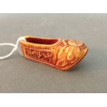 A vintage Chinese hand carved miniature shoe.