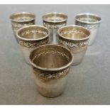 A set of 6 white metal shot cups.