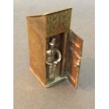An unusual old brass "outhouse" novelty vesta case, door opens to reveal man sitting.