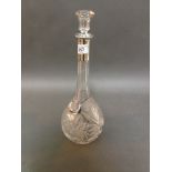 A glass decanter with silver collar, marked 800 and "Champaigne" label.