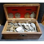 An oak money box containing a collection of assorted GB and world coins & medals