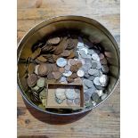 A tin of assorted GB coins to include some silver.