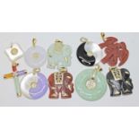 A group of ten hard stone pendants including jadeite jade, yellow metal mounts, some marked '14K',