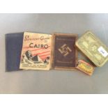 A collection of militaria to include a WW1 Christmas tin, a trench art copper and brass matchbox