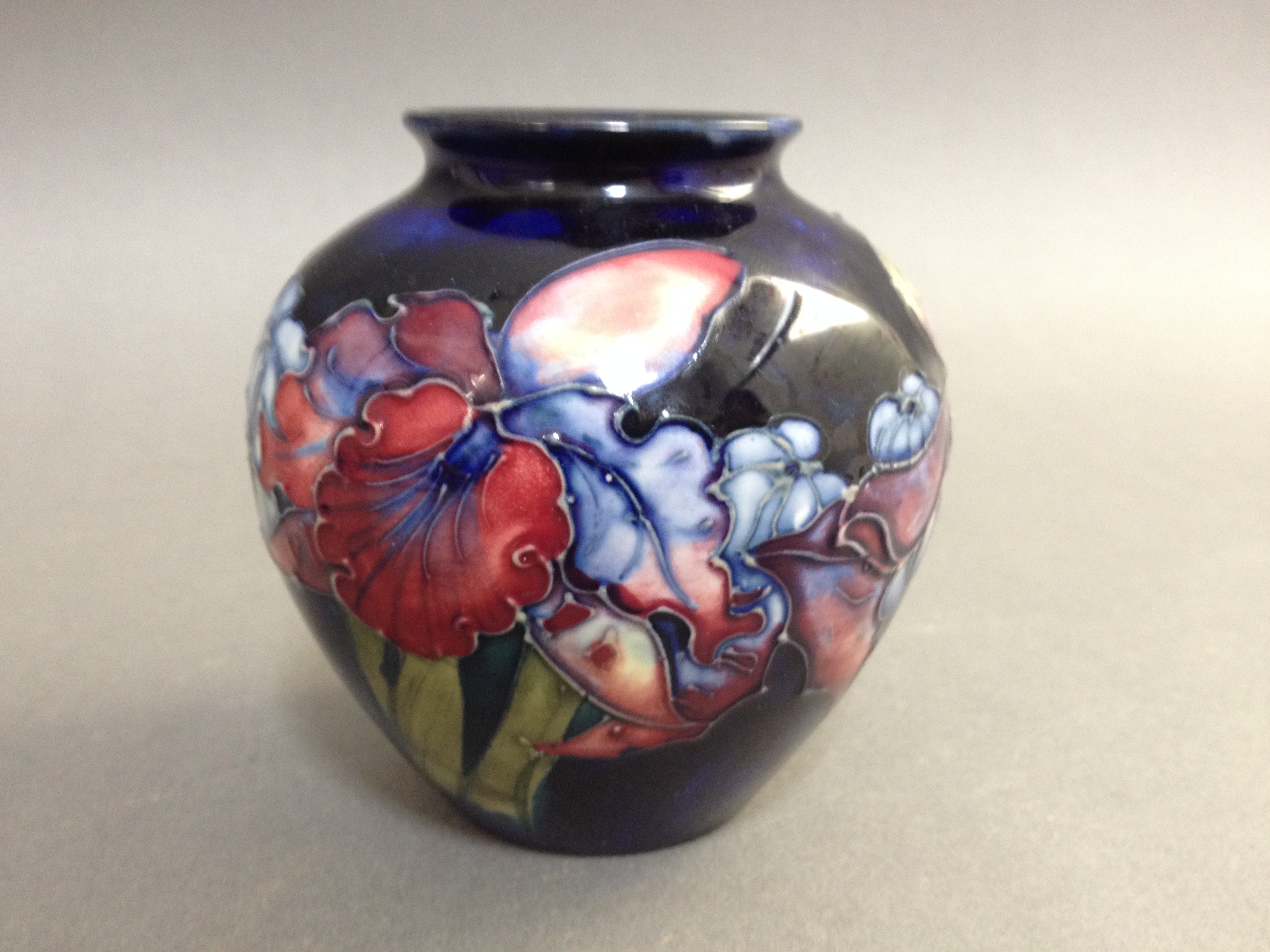 A Moorcroft pottery squat vase, height 9.5cm. Condition - good, no damage/repair, general wear.