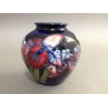 A Moorcroft pottery squat vase, height 9.5cm. Condition - good, no damage/repair, general wear.