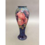 A Moorcroft pottery vase of inverted baluster form, tube line decoration depicting pomegranates,
