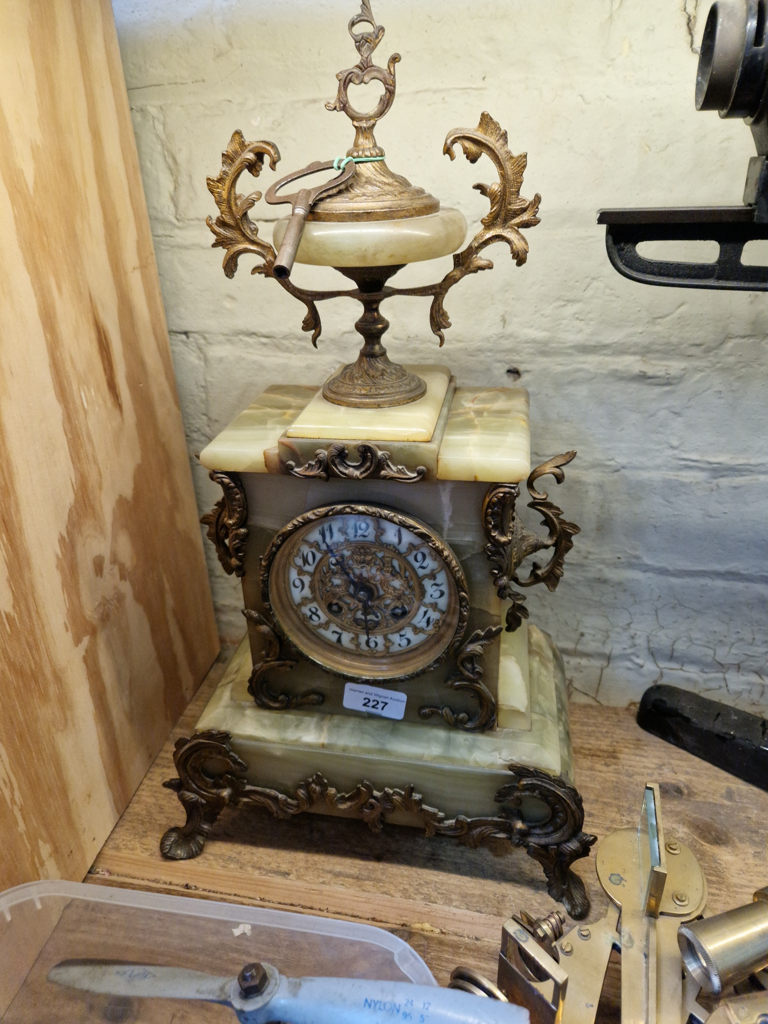 A french onyx and brass mantle clock, height 49cm.