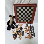 Two chess sets, a chess board and a vintage panda toy.
