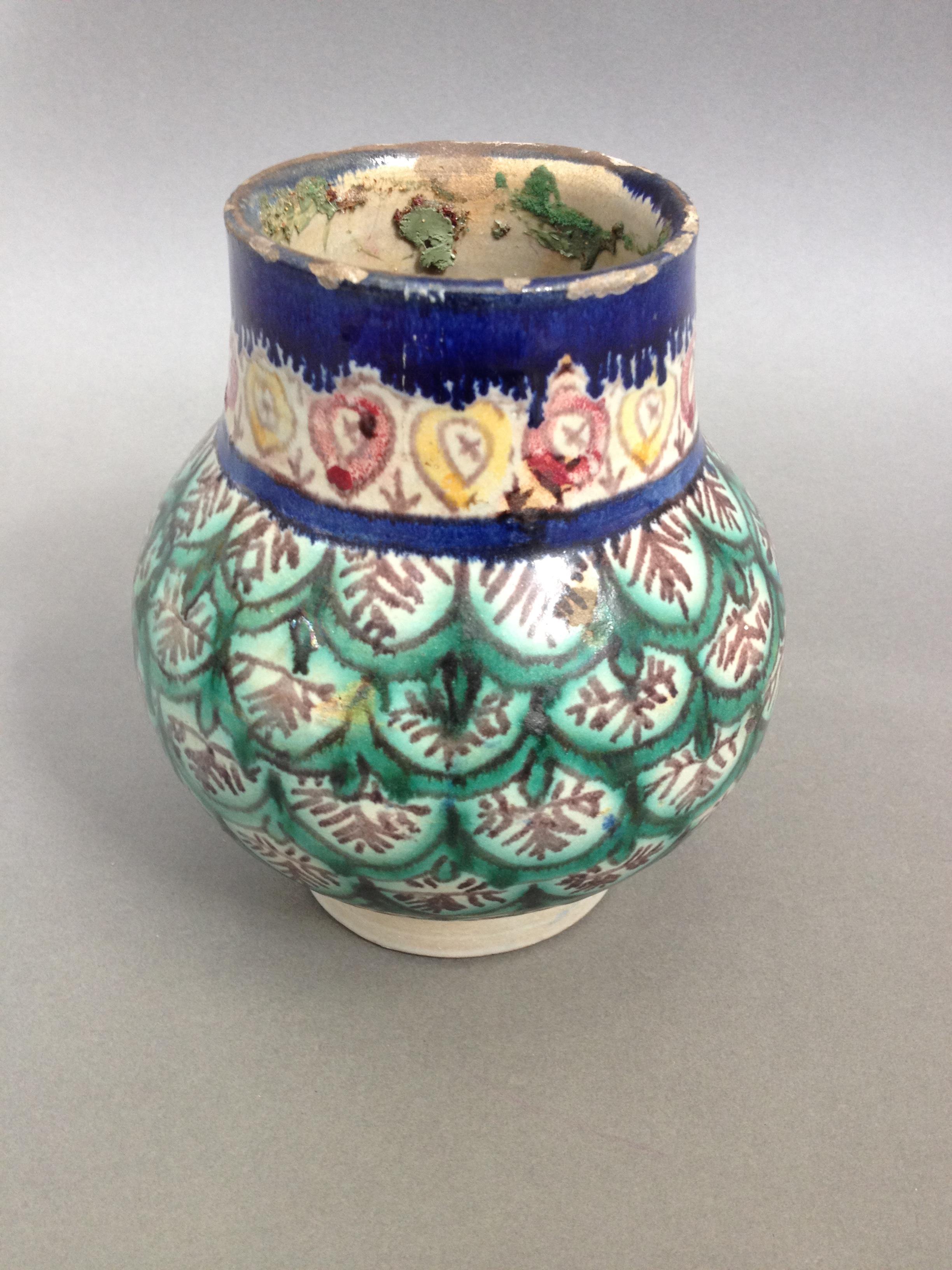 An Isnik pottery vase, height 16cm. Condition - losses to finish around rim, appears free from any