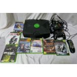 An Xbox games console, controllers and ieven games.