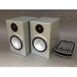 A pair of Monitor Audio Silver RS1 loudspeakers with metal stands.